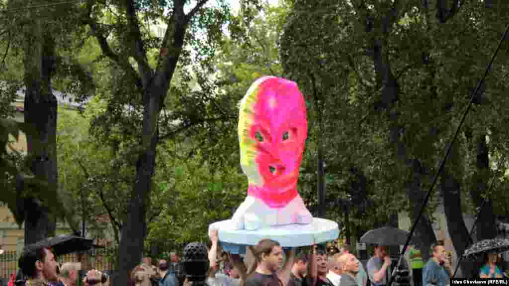 Demonstrators carried a model of a colorful balaclava mask -- the symbol of the jailed female protesters of the punk group Pussy Riot.