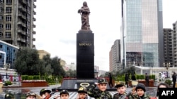 Azerbaijan -- Wearing army-style camouflage costumes little Azerbaijanis take part in a ceremony to mark 21st anniversary of what Azerbaijan refers to as the "Khojaly Massacre" at a monument to the Khojaly victims in Baku, 25Feb2013