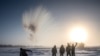 RUSSIA - A villager throws hot water into the air while harvesting ice from a local lake near the settlement of Oy, some 70 km south of Yakutsk, with the air temperature at about minus 41 degrees Celsius, on November 27, 2018